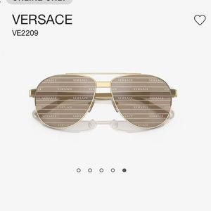 Versace gold aviators with monogrammed lenses that say “Versace” in the light.